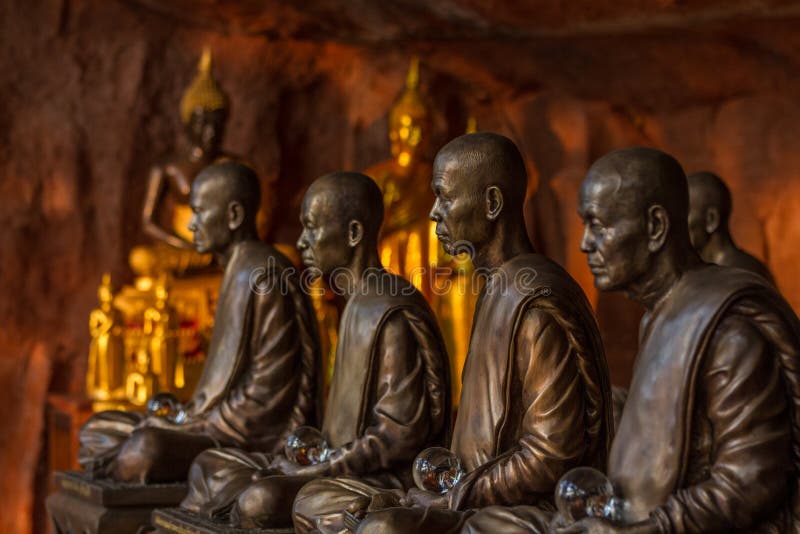 Buddhist monks statues symbol of peace and serenity at Wat Phu Tok temple, Thailand, asceticism and meditation, buddhist art work