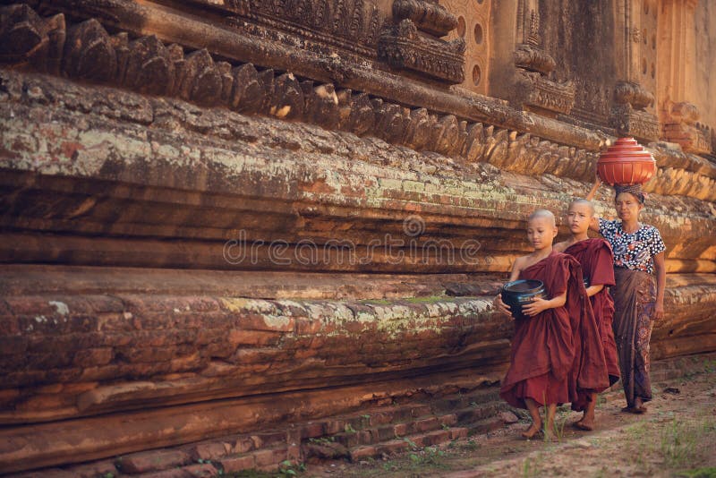 Buddhist novice monks walking alms stock photos