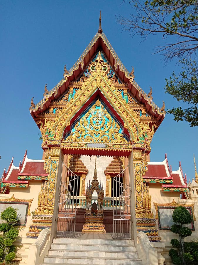 Buddhist temple entrance gate of church isolated on blue sky background closeup. Buddhist temple entrance gate of church isolated on blue sky background closeup stock photo Buddhist temple entrance gate of church isolated on blue sky background closeup. Buddhist temple entrance gate of church isolated on blue sky background closeup stock photo