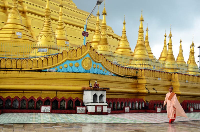 Buddhist woman ascetic or nun walking at Shwemawdaw Paya Pagoda in Bago, Myanmar.