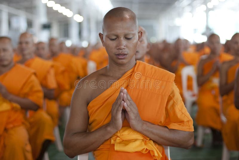 BANGKOK, SEPTEMBER 22. A young Thai Buddhist monk meditates during a mass spiritual event at the Dhammakaya temple north of Bangkok in Thailand on September 22, 2011. The Dhammakaya temple is the largest religious physical structure in the world although it is not recognized by the main governing body of Buddhist organizations in Thailand. BANGKOK, SEPTEMBER 22. A young Thai Buddhist monk meditates during a mass spiritual event at the Dhammakaya temple north of Bangkok in Thailand on September 22, 2011. The Dhammakaya temple is the largest religious physical structure in the world although it is not recognized by the main governing body of Buddhist organizations in Thailand.