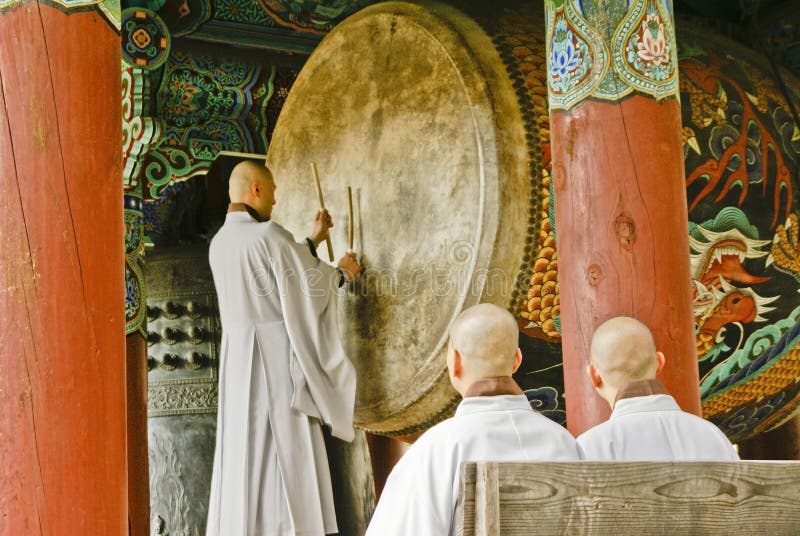 A Buddhist monk beats an enormous drum at Haeinsa, one of Korea`s three Jewel Temples, in Gayasan National Park, South Korea. A Buddhist monk beats an enormous drum at Haeinsa, one of Korea`s three Jewel Temples, in Gayasan National Park, South Korea.