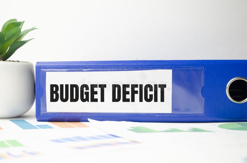 BUDGET DEFICIT text on folder with chart and calculator on white background