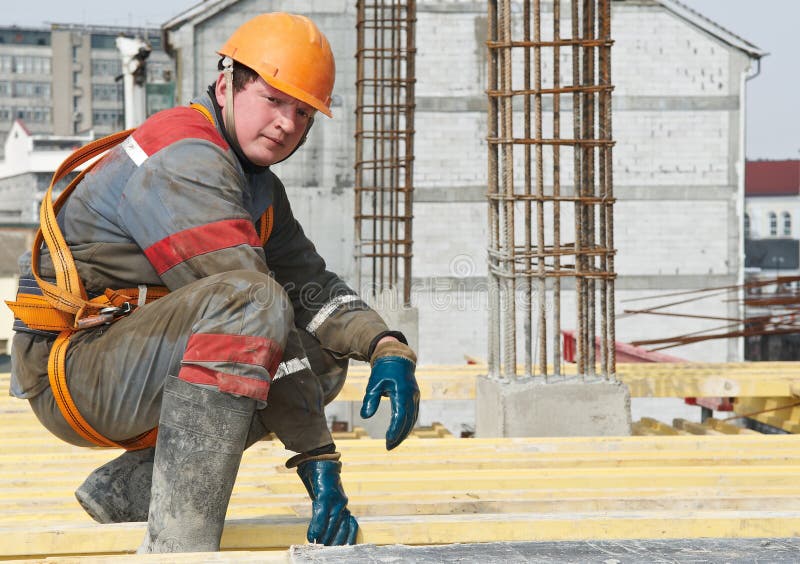 Young builder worker in work wear, helmet and equipment at house building area. Young builder worker in work wear, helmet and equipment at house building area