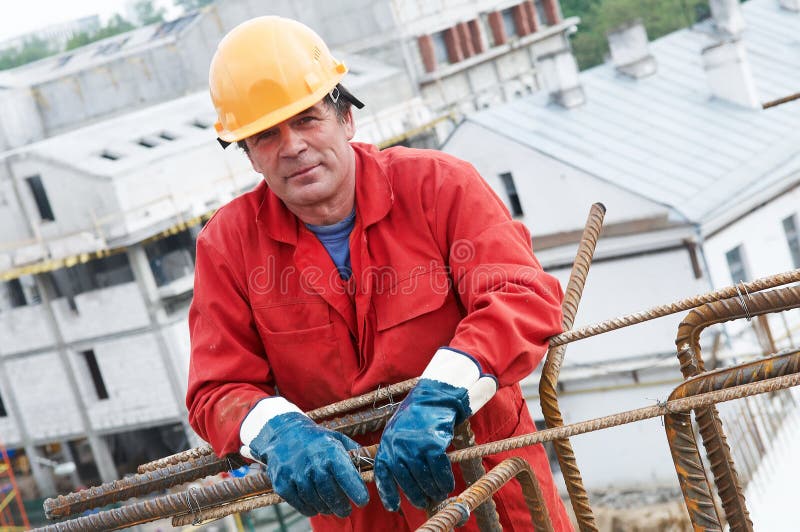 Handsome adult worker building at construction site. Handsome adult worker building at construction site