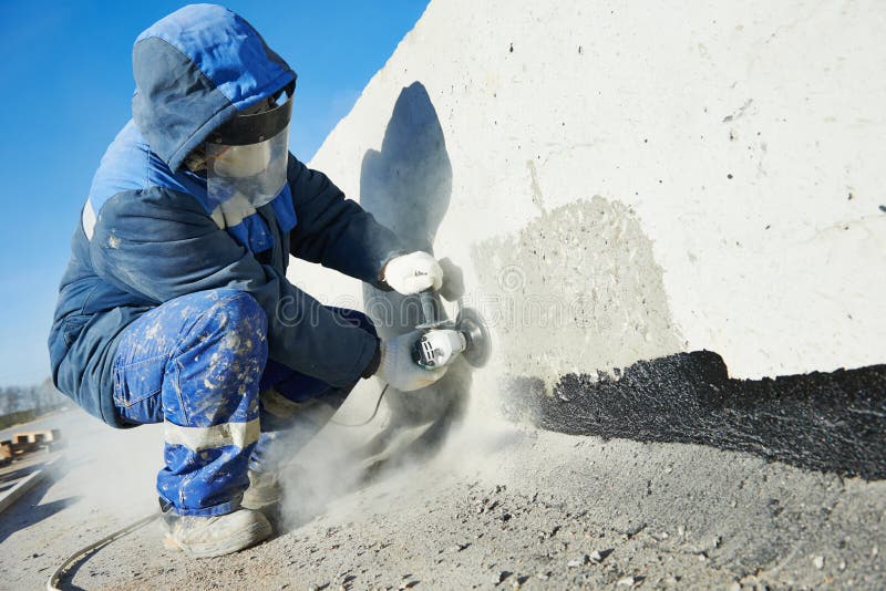 Builder worker with grinder machine cutting metal parts at construction site. Builder worker with grinder machine cutting metal parts at construction site