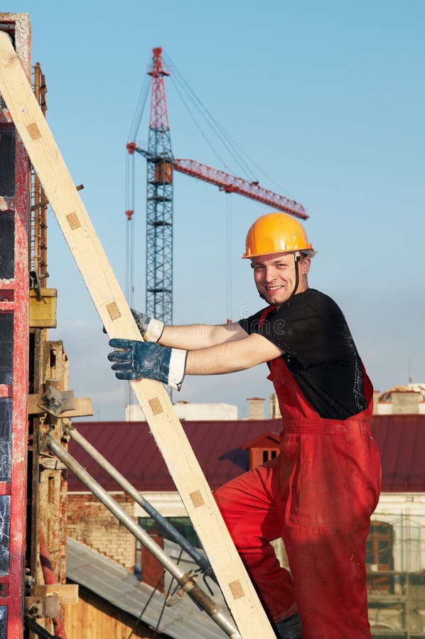 Young happy smiling worker builder at construction site. Young happy smiling worker builder at construction site