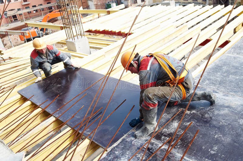 Builders working in protective wear, helmet and equipment. Builders working in protective wear, helmet and equipment