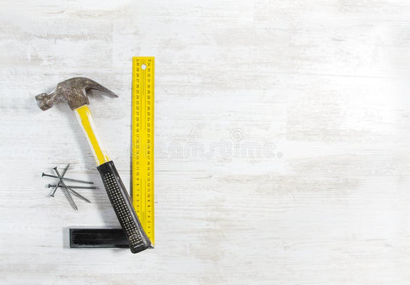 Hammer with nails and ruler. Tools set for construction work over wooden background. Hammer with nails and ruler. Tools set for construction work over wooden background.