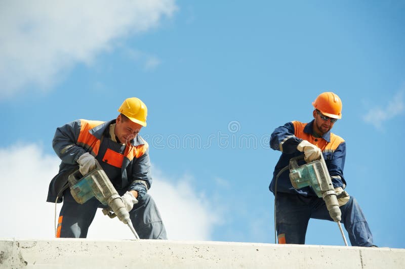 Two Builder workers with pneumatic hammer drill equipment at construction site. Two Builder workers with pneumatic hammer drill equipment at construction site