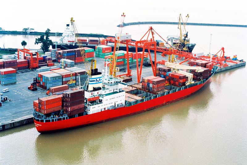 BUENOS AIRES, ARGENTINA - DECEMBER 16, 2012: Cargo ships with shipping containers at a container terminal in Puerto Nuovo, Buenos Aires, Argentina on a overcast weather air viuc maqueira year 2017. BUENOS AIRES, ARGENTINA - DECEMBER 16, 2012: Cargo ships with shipping containers at a container terminal in Puerto Nuovo, Buenos Aires, Argentina on a overcast weather air viuc maqueira year 2017