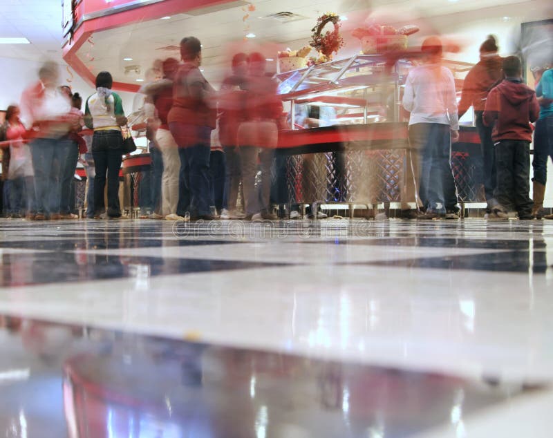 An all you can eat pizza/cafeteria joint - the shot is from the checkered floor looking across at the food line and with a time exposure, some of the customer movement is blurred. An all you can eat pizza/cafeteria joint - the shot is from the checkered floor looking across at the food line and with a time exposure, some of the customer movement is blurred