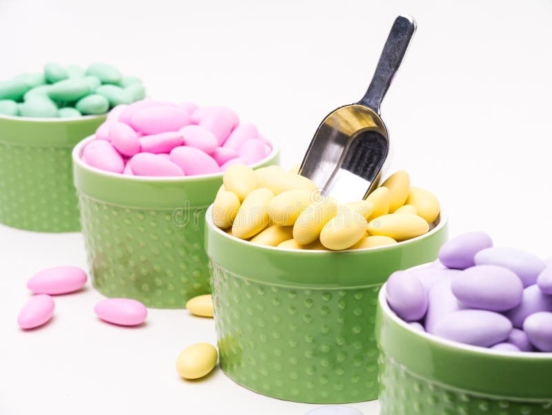 A row of candy filled ramekins on a candy buffet table. A row of candy filled ramekins on a candy buffet table.