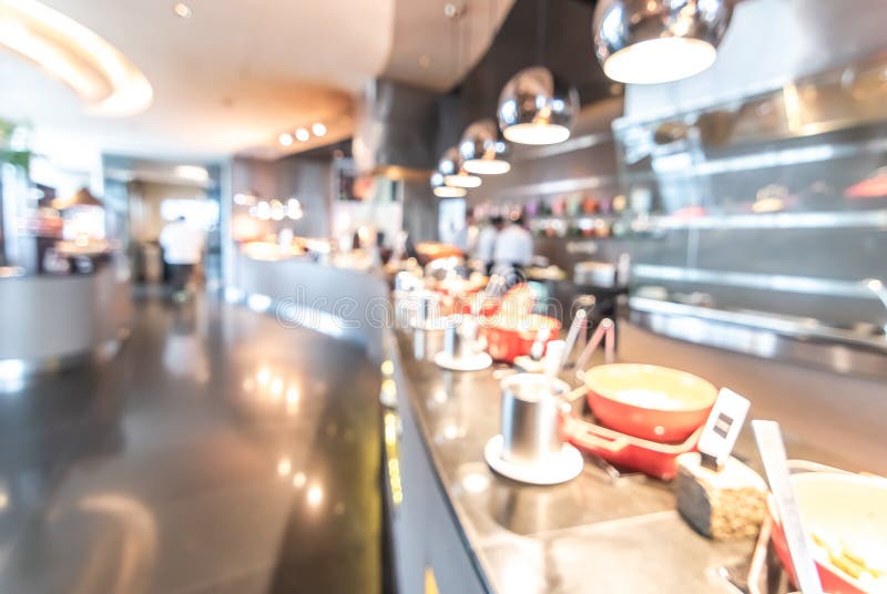 Buffet at hotel restaurant interior blur background with blurry open kitchen counter bar of food catering service business