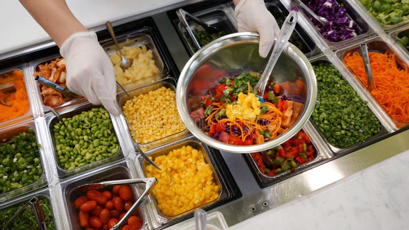 Buffet table filled with a variety of fresh vegetables stock images