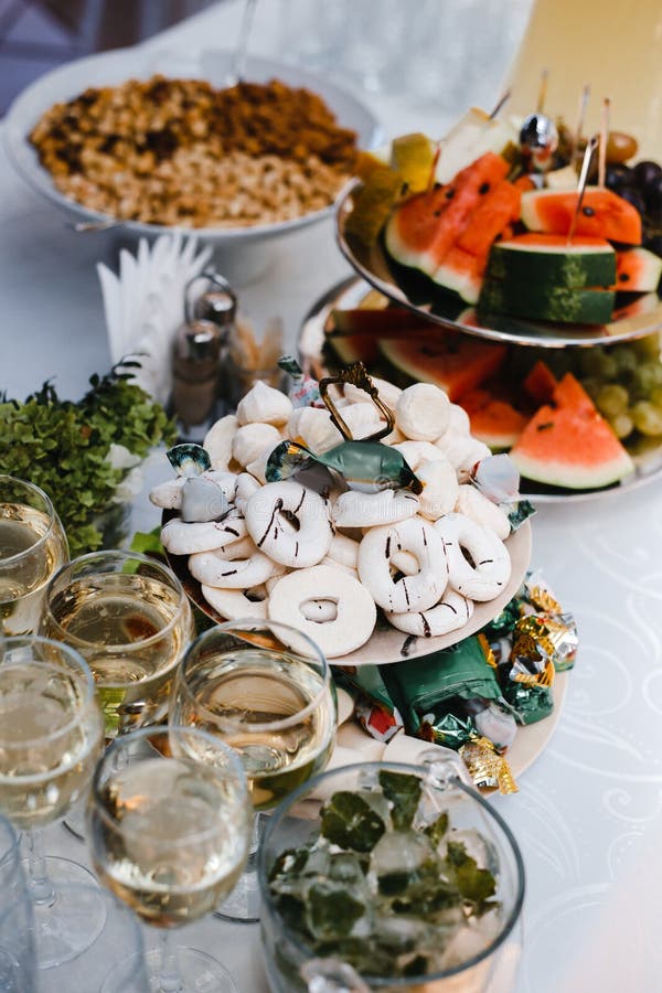 Buffet table with wine and juice, fruits and sweets, snacks and mint ice stock photo