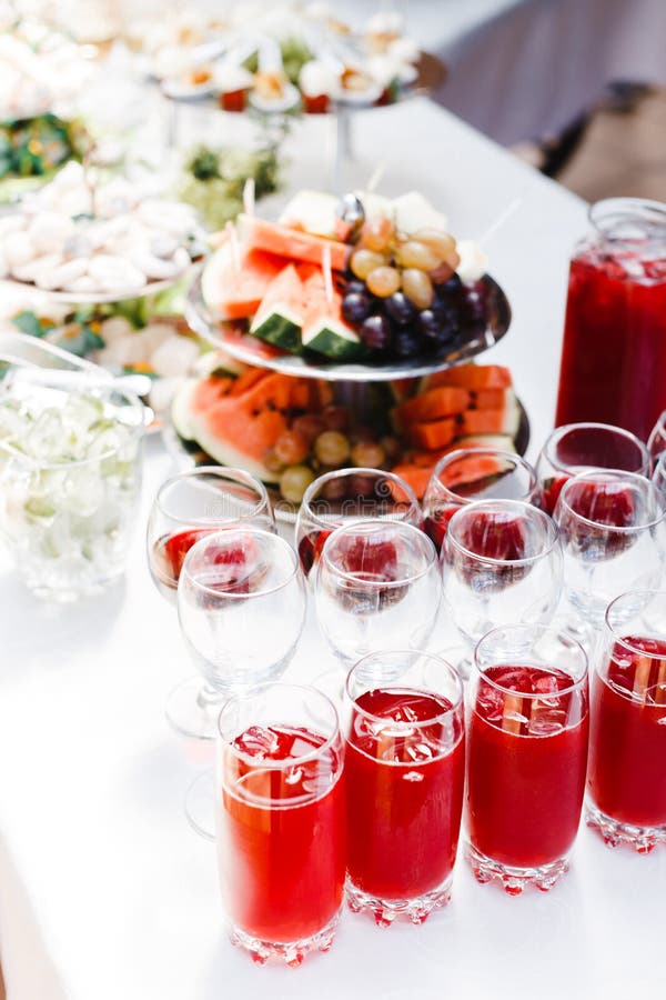 Buffet table with wine and juice, fruits and sweets, snacks and mint ice royalty free stock photos