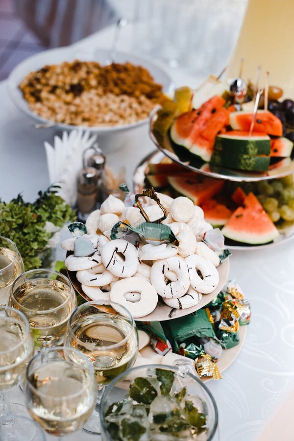 Buffet table with wine and juice, fruits and sweets, snacks and mint ice royalty free stock images
