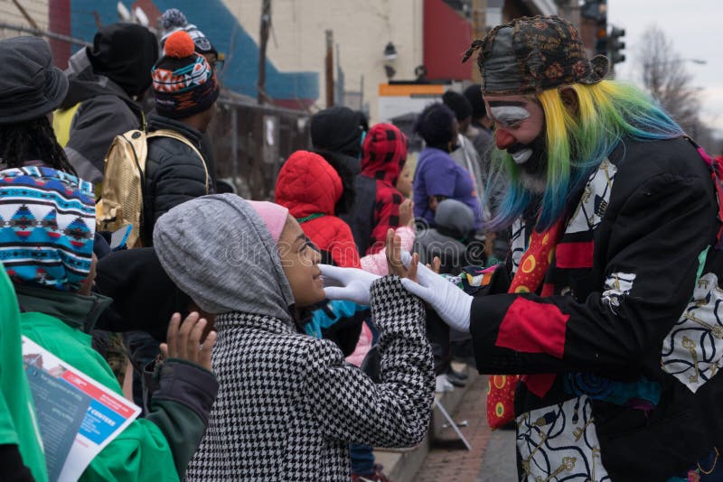 Washington, DC - January 16, 2017: A clown entertains a child during the Martin Luther King, Jr. Day Peace Walk and Parade. Washington, DC - January 16, 2017: A clown entertains a child during the Martin Luther King, Jr. Day Peace Walk and Parade.