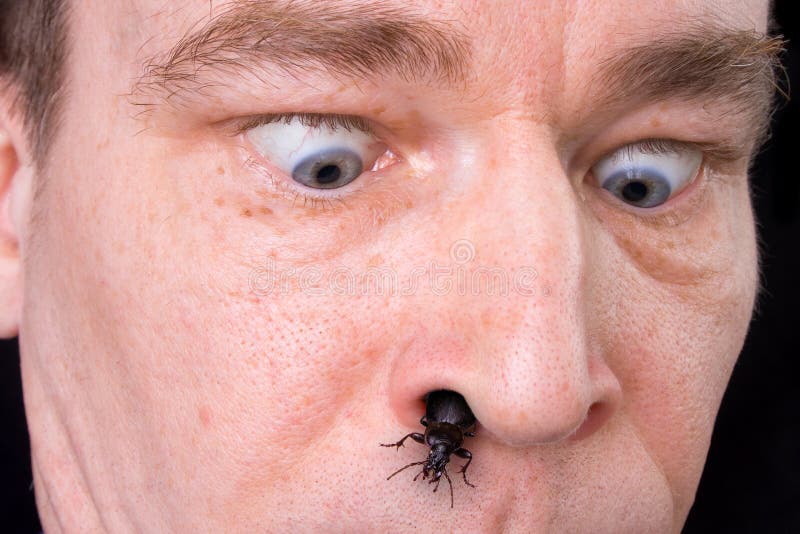 Scared man with the bug coming from his nose. Scared man with the bug coming from his nose.