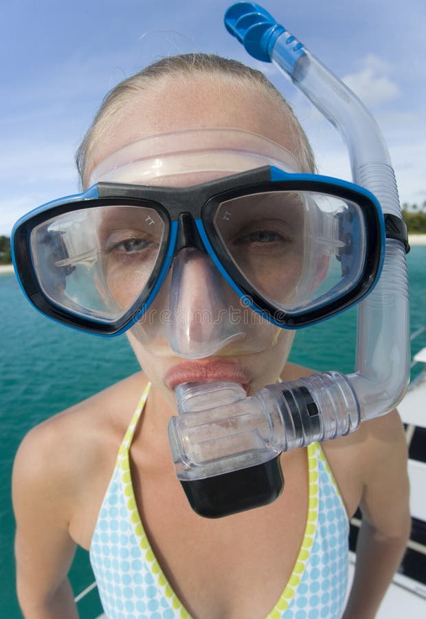 Funny bug-eyed teenage girl in a snorkel mask. On vacation in Fiji in the South Pacific. Funny bug-eyed teenage girl in a snorkel mask. On vacation in Fiji in the South Pacific.