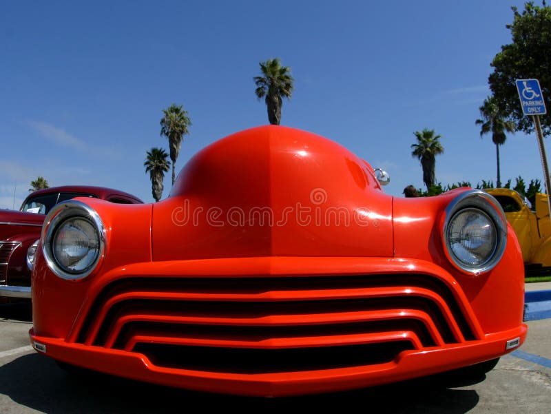 A modified retro classic car looks as if it has bug eyes.