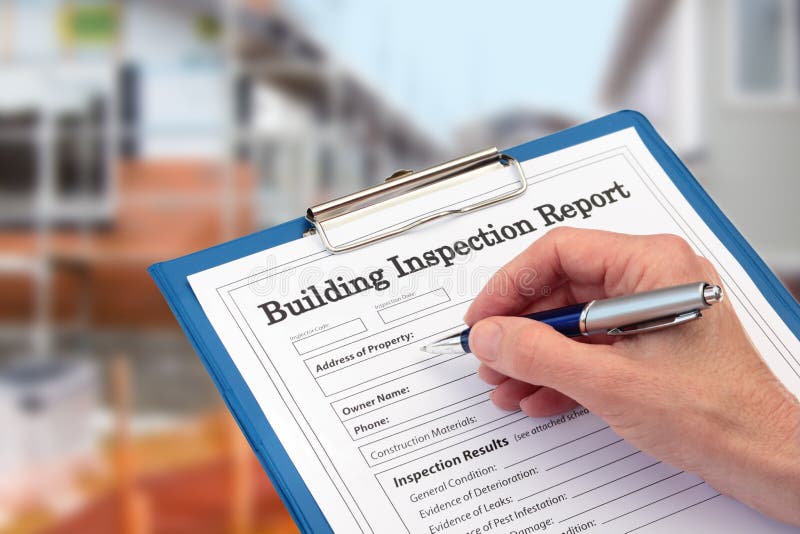 Buiding Inspector completing an inspection form on clipboard