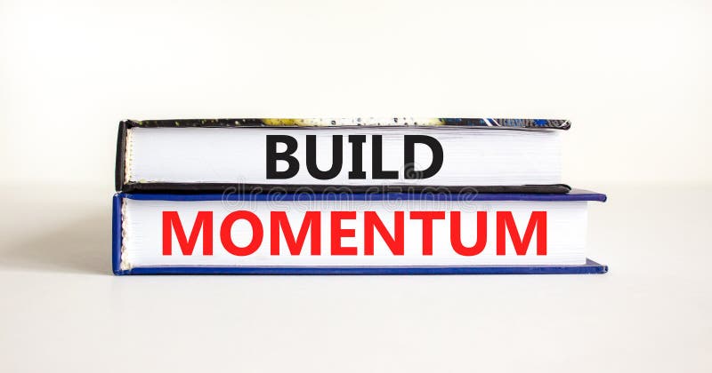 Build momentum symbol. Concept words Build momentum on books. Beautiful white table white background. Business and build momentum stock photography