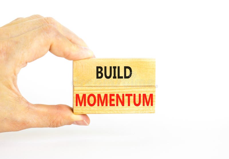 Build momentum symbol. Concept words Build momentum on wooden blocks. Beautiful white table white background. Businessman hand. stock image