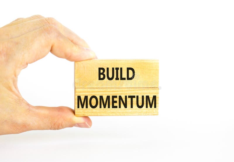 Build momentum symbol. Concept words Build momentum on wooden blocks. Beautiful white table white background. Businessman hand. royalty free stock images