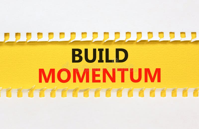 Build momentum symbol. Concept words Build momentum on yellow paper. Beautiful white background. Business and build momentum stock photo