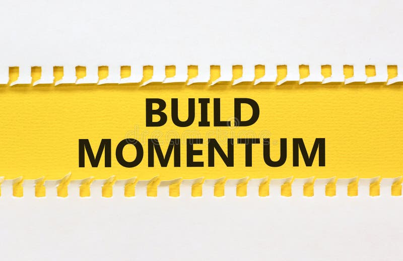 Build momentum symbol. Concept words Build momentum on yellow paper. Beautiful white background. Business and build momentum royalty free stock photos