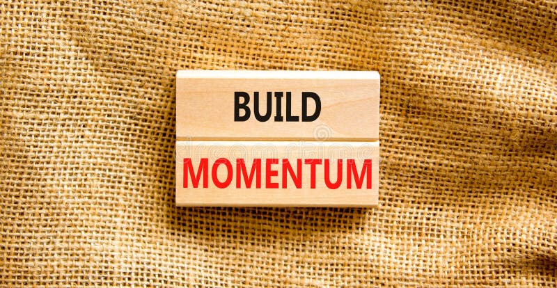Build momentum symbol. Concept words Build momentum on wooden blocks. Beautiful canvas table canvas background. Business and build stock photography