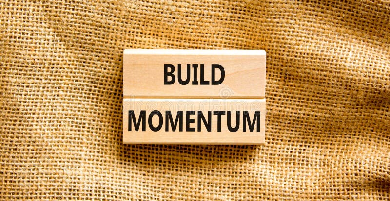 Build momentum symbol. Concept words Build momentum on wooden blocks. Beautiful canvas table canvas background. Business and build royalty free stock photo