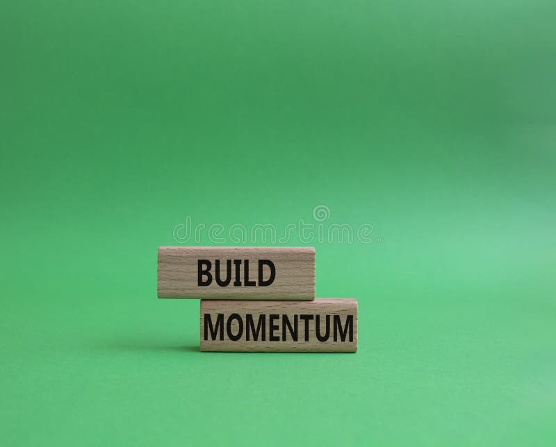 Build momentum symbol. Wooden blocks with words Build momentum. Beautiful green background. Business and Build momentum concept. royalty free stock image