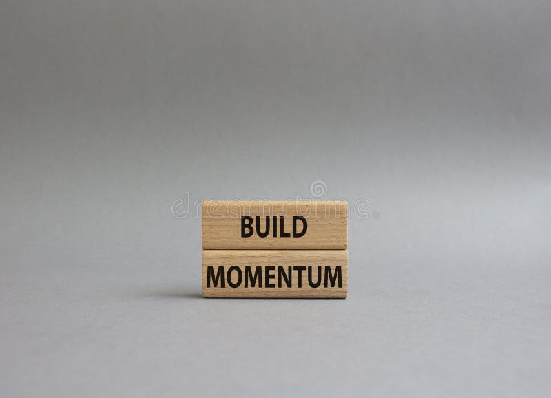 Build momentum symbol. Wooden blocks with words Build momentum. Beautiful grey background. Business and Build momentum concept. royalty free stock photo