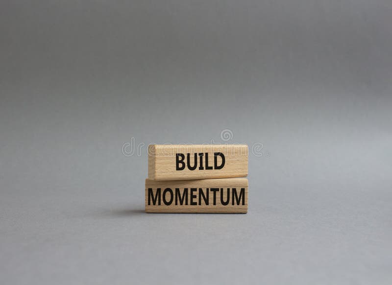 Build momentum symbol. Wooden blocks with words Build momentum. Beautiful grey background. Business and Build momentum concept. royalty free stock photo