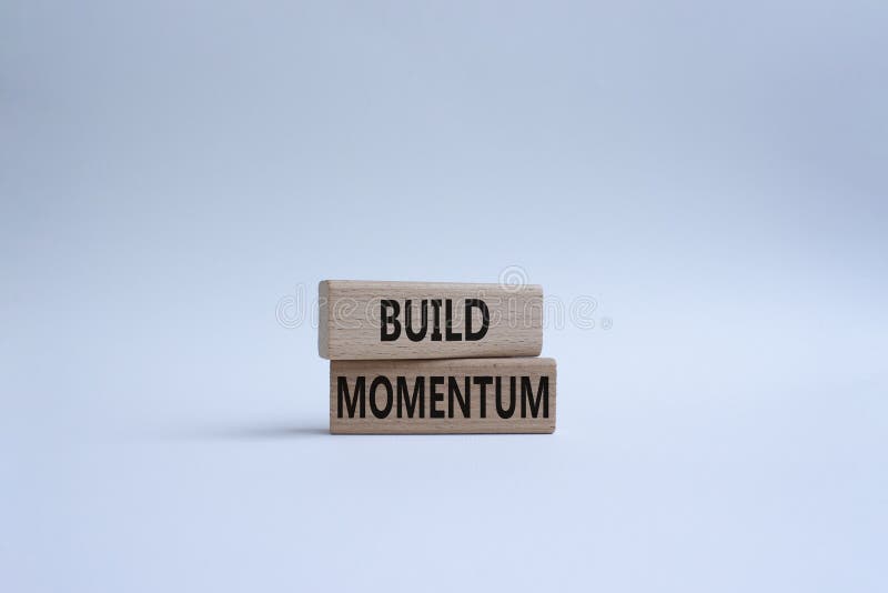 Build momentum symbol. Wooden blocks with words Build momentum. Beautiful white background. Business and Build momentum concept. royalty free stock photography