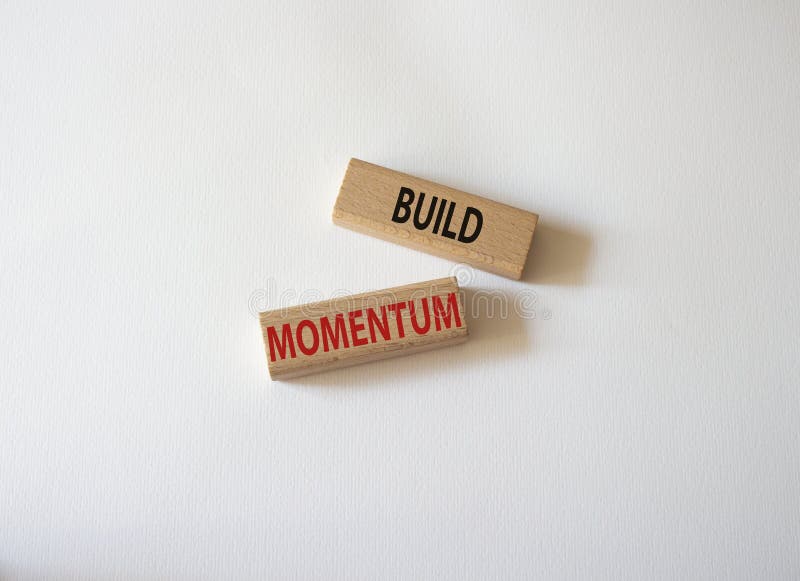 Build momentum symbol. Wooden blocks with words Build momentum. Beautiful white background. Business and Build momentum concept. royalty free stock images