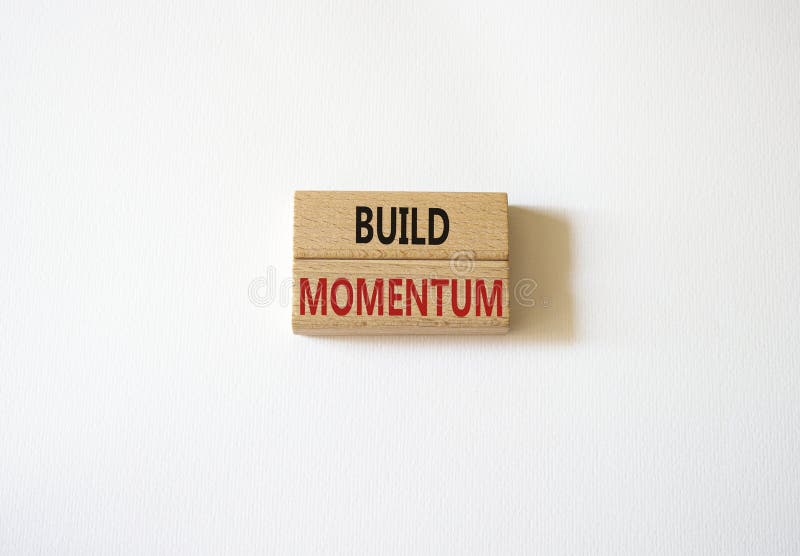 Build momentum symbol. Wooden blocks with words Build momentum. Beautiful white background. Business and Build momentum concept. royalty free stock images