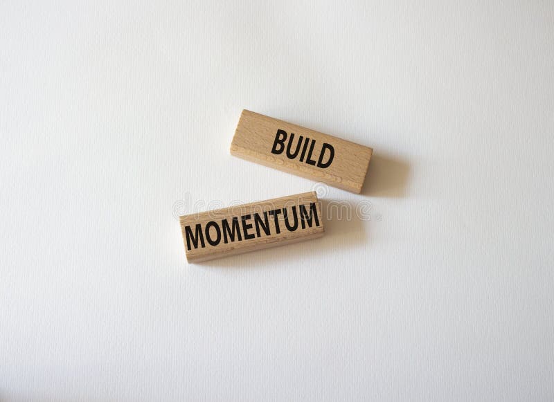 Build momentum symbol. Wooden blocks with words Build momentum. Beautiful white background. Business and Build momentum concept. royalty free stock images