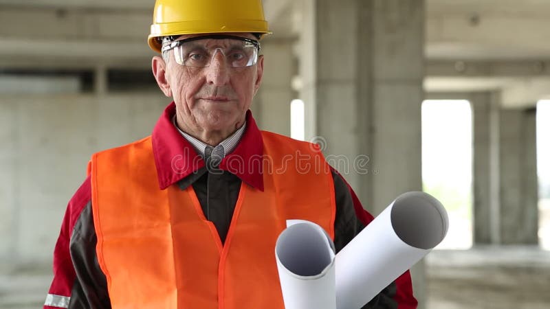 Builder with building drawings at project site