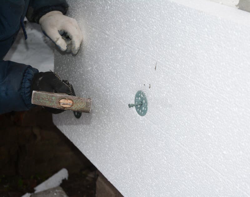 Builder Contractor Installing Rigid Styrofoam Insulation Board with