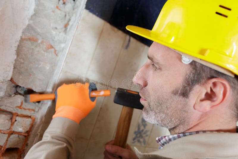 Builder Hitting Wall with Hammer Stock Photo Image of industry, adult 261516376
