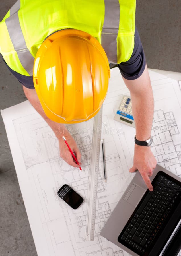 Builder inspects construction plans.