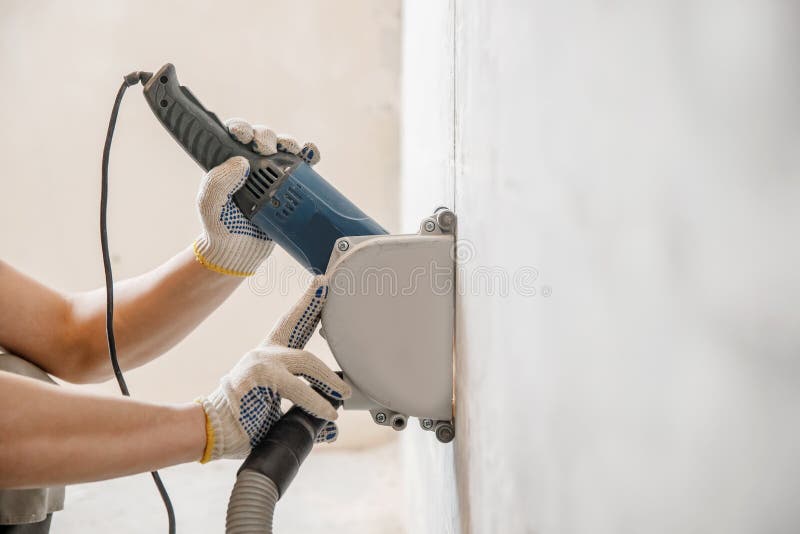 Builder Man Cutting Electrical Chase in Concrete Wall with Circulation Saw Drill Diamond Crown