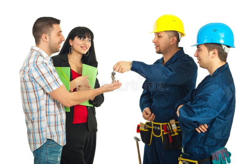 Builder men team give house keys to a couple stock photos