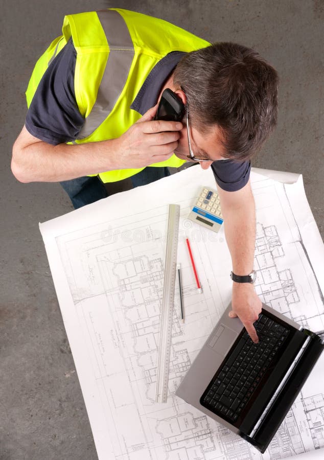 Builder phones about construction blueprint