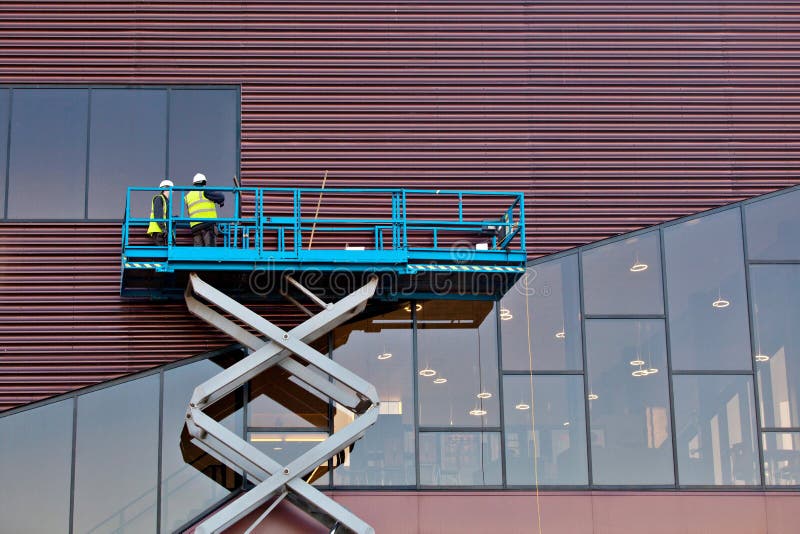 Builder on a Scissor Lift Platform at a construction site