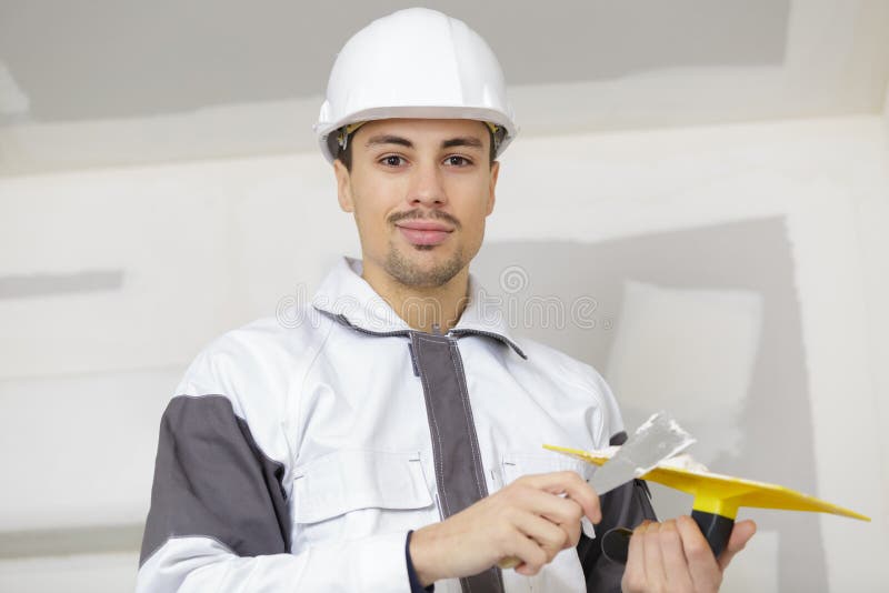 Builder with spatula with plaster in hand royalty free stock photo Builder with spatula with plaster in hand royalty free stock photo